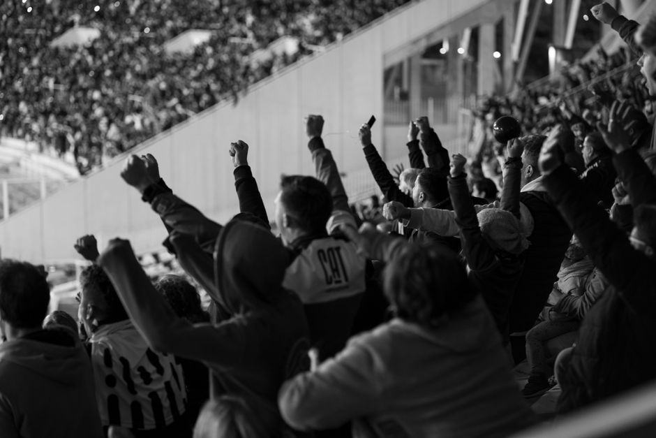 Vibrant crowd of football fans cheering in a Córdoba stadium, Argentina.