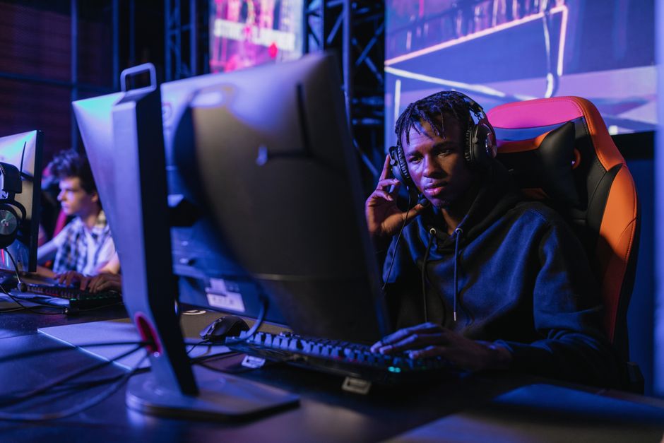 Young man immersed in competitive gaming at an eSports event.